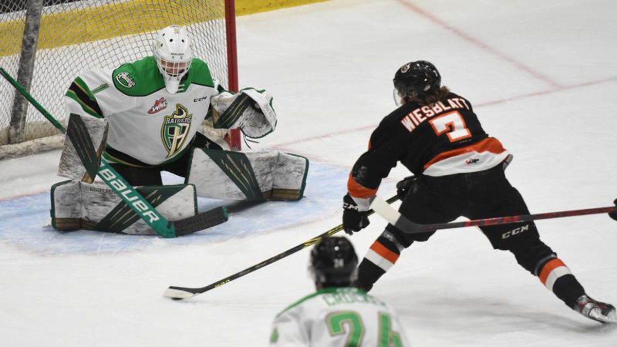 Prince Albert Raiders player Ozzy Wiesblatt, lt, collides with Calgary  Hitmen (wearing Calgary Wranglers retro jerseys) player Sean Tschigeri  during WHL (Western Hockey League) hockey action in Calgary, Alta., on  Friday, Feb.